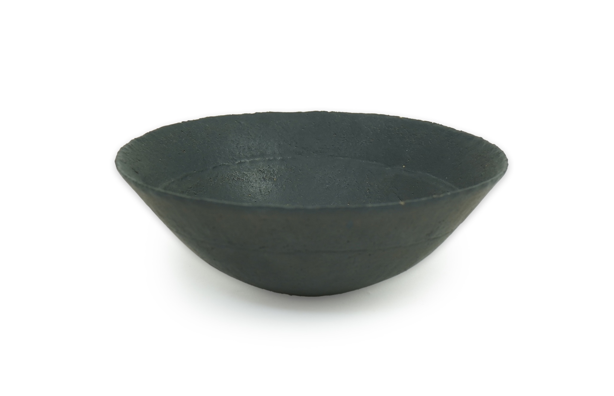 John Ward (1938-2023): A hand-built stoneware black glazed bowl with irregular rim